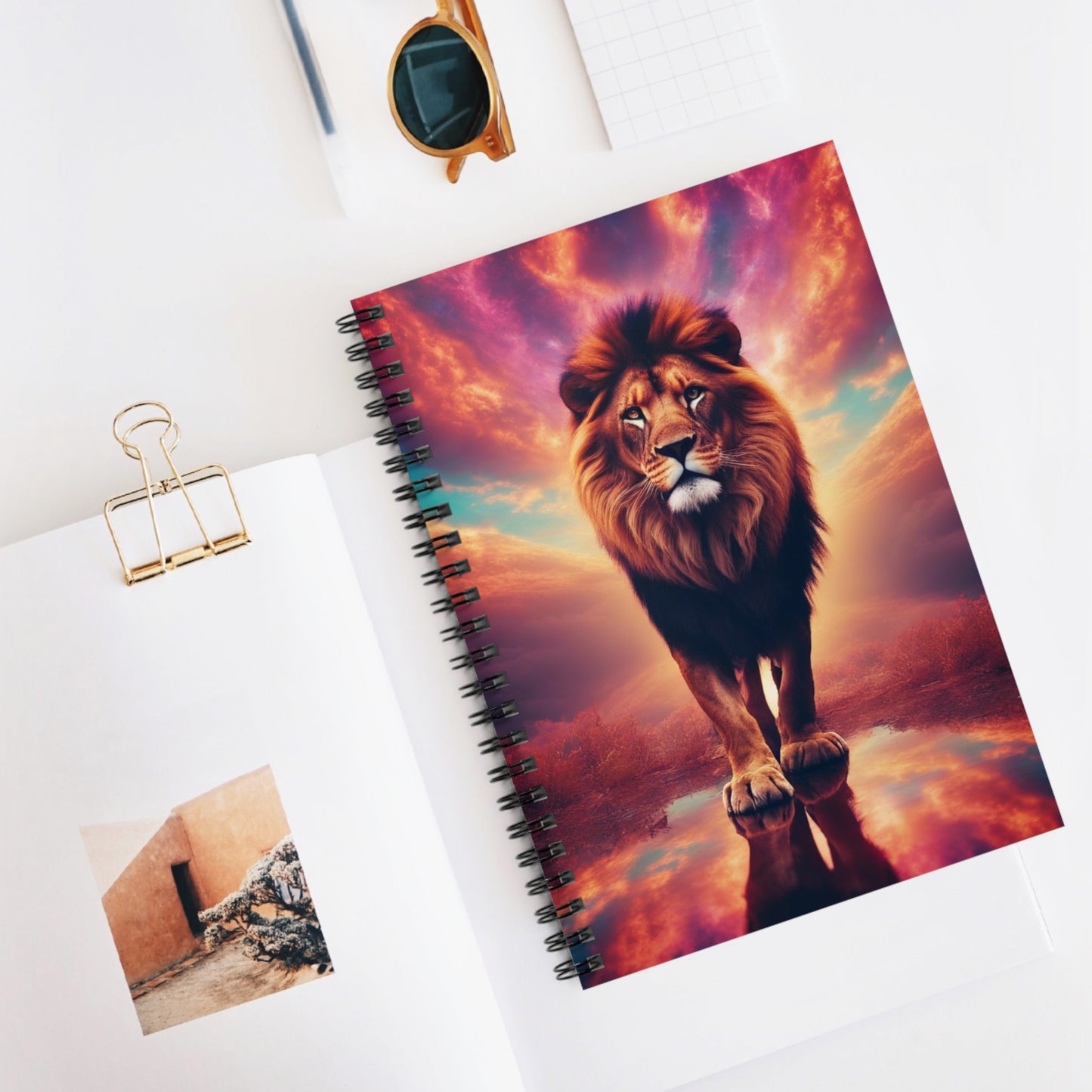 The Lone Lion Majesty Notebook on a desk with writing essentials, creating an inspiring workspace.
